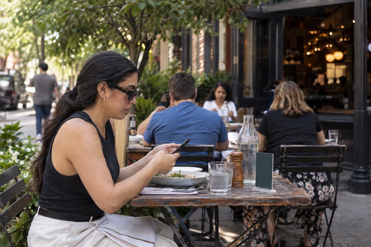 Guests at a Brooklyn sidewalk table order from a phone instead of waiting for a server